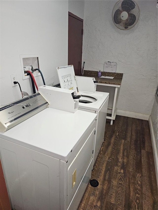 laundry area featuring dark hardwood / wood-style floors and washer and dryer