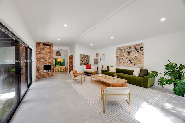 living room with a brick fireplace and vaulted ceiling