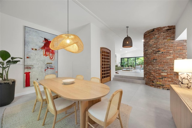 dining space with vaulted ceiling