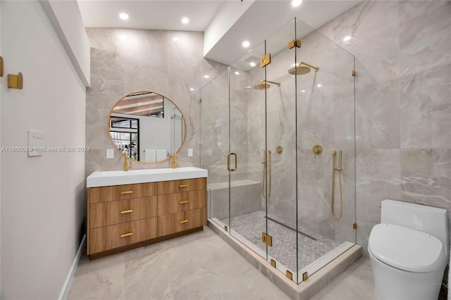 bathroom featuring vanity, tile walls, a shower with shower door, and toilet