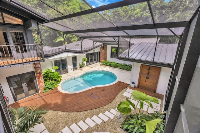 view of swimming pool featuring a lanai and a patio area