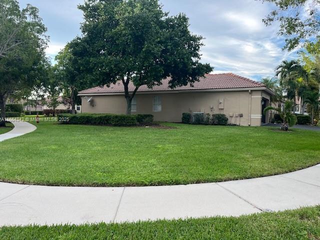 view of home's exterior with a lawn