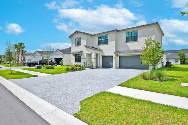 view of front of house with a garage and a front lawn