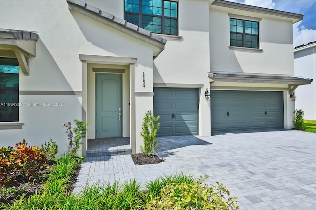 doorway to property with a garage