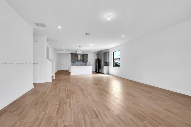 unfurnished living room with light hardwood / wood-style flooring