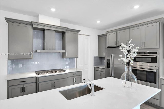 kitchen with gray cabinets, appliances with stainless steel finishes, sink, and decorative backsplash