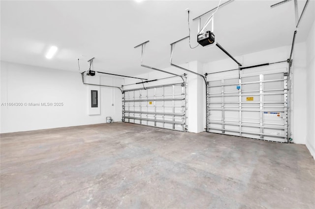 garage featuring a garage door opener and electric panel