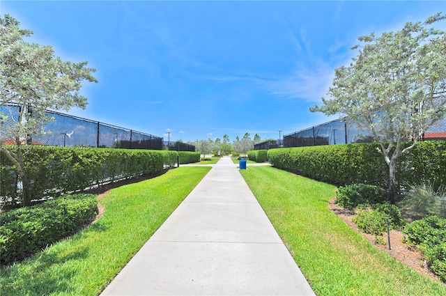 view of property's community featuring a yard