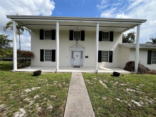 view of front of property with a patio area and a front yard