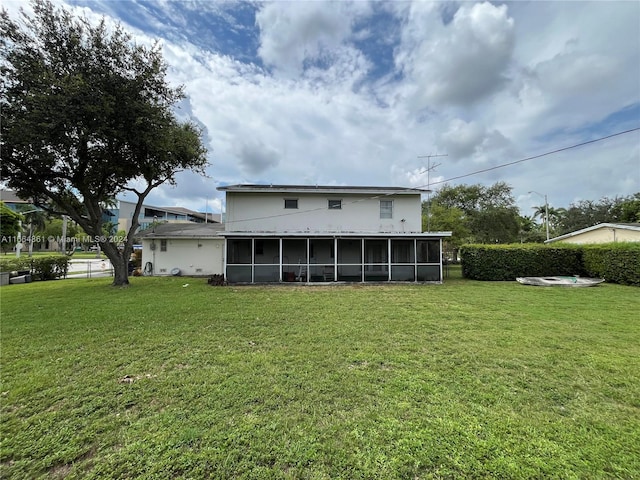 8901 SW 88th St, Miami, FL 33176 - rear view of house featuring a lawn and a sunroom