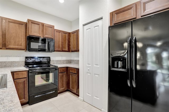 kitchen featuring black appliances and light tile patterned flooring