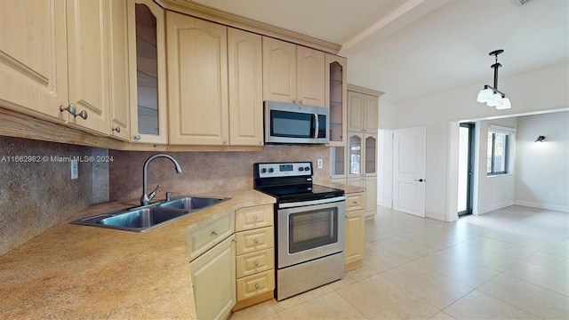 kitchen featuring pendant lighting, sink, decorative backsplash, appliances with stainless steel finishes, and light brown cabinetry