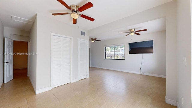 spare room featuring light tile patterned floors and ceiling fan