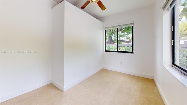 tiled empty room with ceiling fan