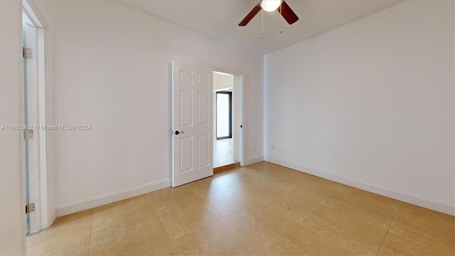 spare room featuring ceiling fan and light tile patterned flooring