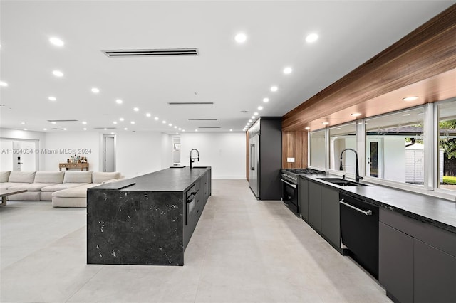 kitchen with a large island, appliances with stainless steel finishes, and sink