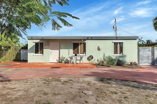 rear view of property featuring a porch