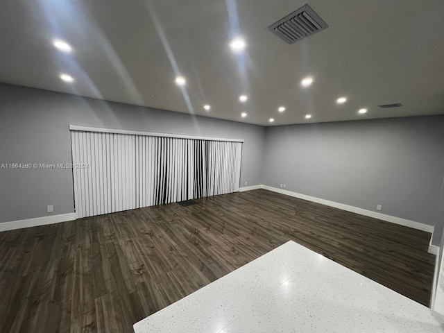 spare room with dark wood-type flooring