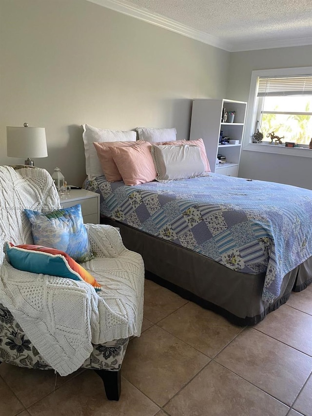 tiled bedroom with a textured ceiling and crown molding