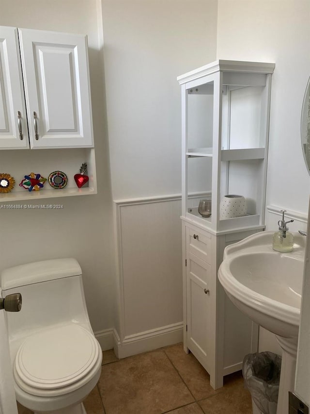 bathroom with tile patterned flooring and toilet