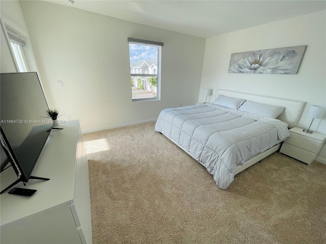 bedroom with light colored carpet