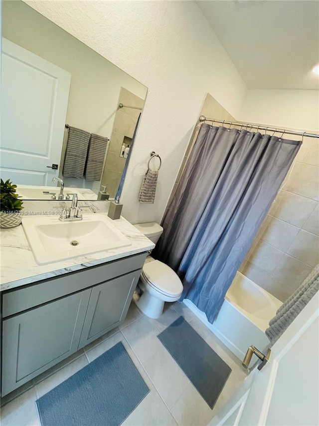 full bathroom with shower / tub combo, tile patterned flooring, vanity, and toilet