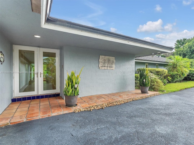 view of side of property with french doors and a patio