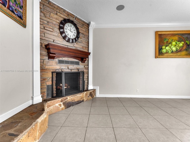 tiled living room featuring ornamental molding, a textured ceiling, and a stone fireplace