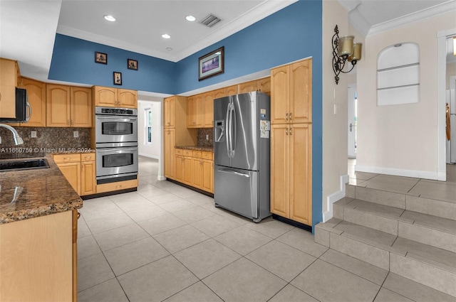 kitchen featuring sink, decorative backsplash, appliances with stainless steel finishes, light tile patterned floors, and crown molding