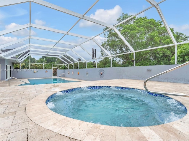 view of swimming pool featuring glass enclosure and a patio area