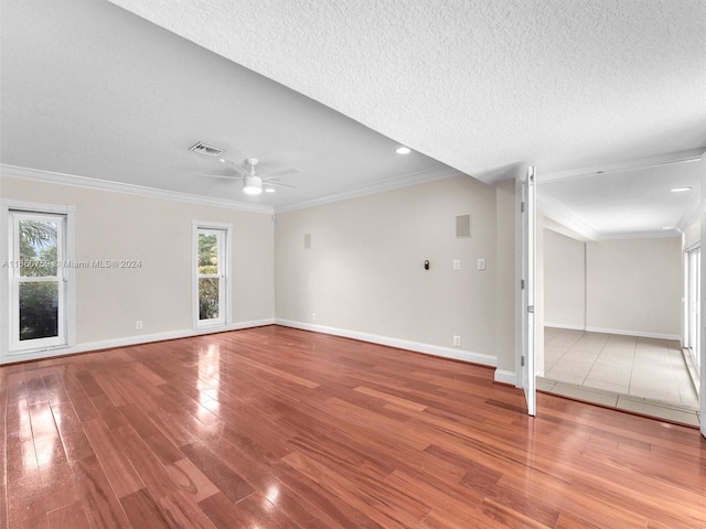 unfurnished living room with ornamental molding, ceiling fan, hardwood / wood-style floors, and a textured ceiling