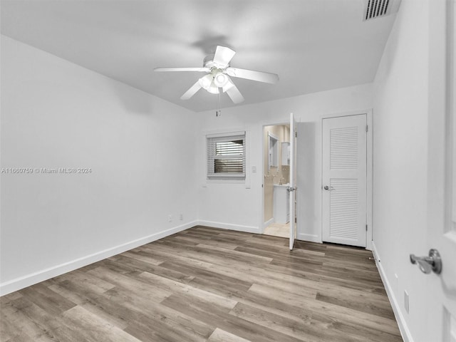 spare room with light wood-type flooring and ceiling fan