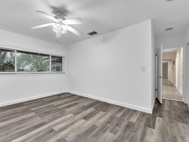 spare room with hardwood / wood-style floors and ceiling fan