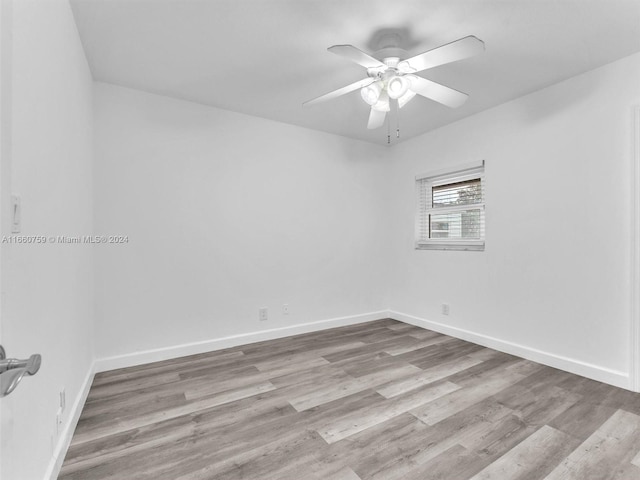 empty room featuring ceiling fan and light hardwood / wood-style flooring