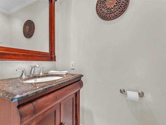 bathroom featuring crown molding and vanity