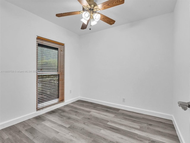 empty room with ceiling fan and light wood-type flooring