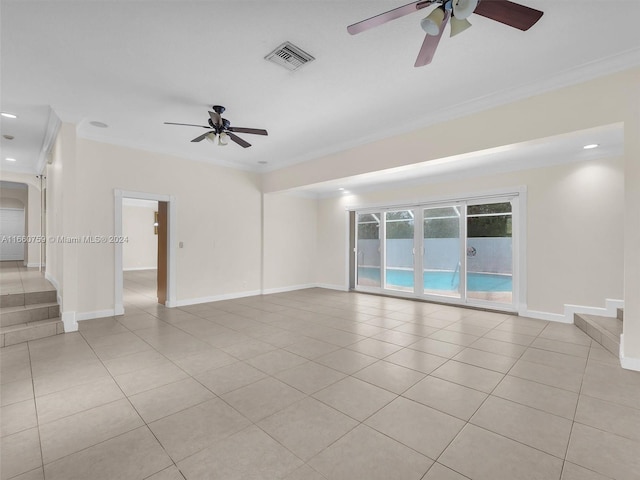 empty room featuring ornamental molding, ceiling fan, and light tile patterned flooring