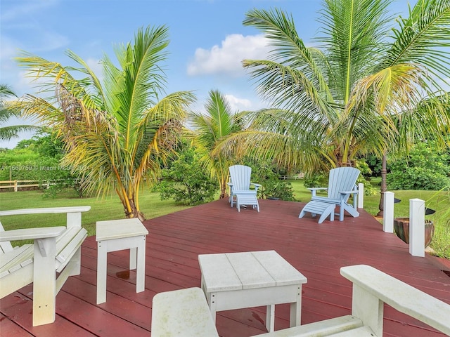 wooden terrace featuring a yard