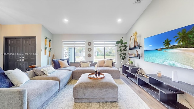 living room featuring light hardwood / wood-style flooring and lofted ceiling