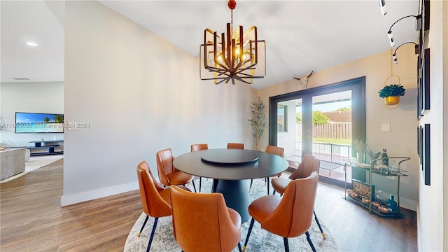 dining room with a notable chandelier and hardwood / wood-style floors