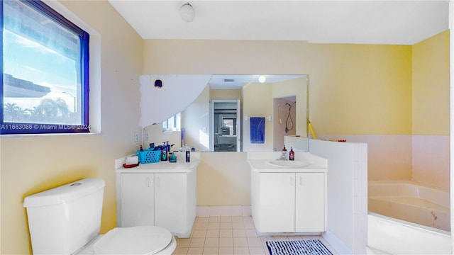 bathroom with vanity, tile patterned flooring, toilet, and a washtub