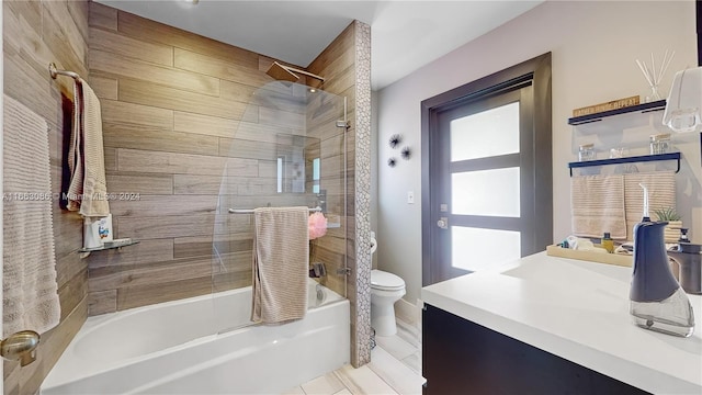 full bathroom with tiled shower / bath, vanity, and toilet