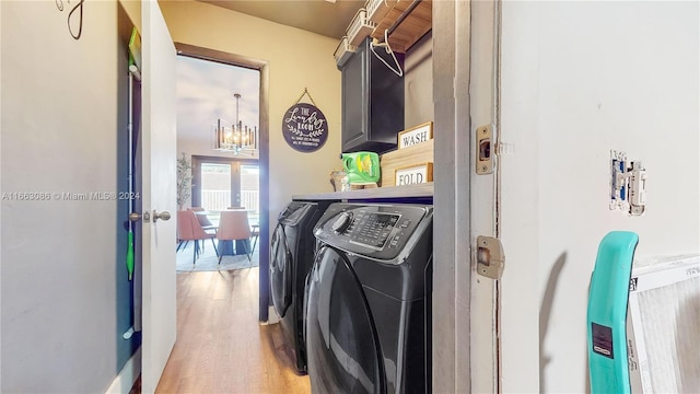 clothes washing area with cabinets, a chandelier, washer and dryer, light hardwood / wood-style flooring, and french doors