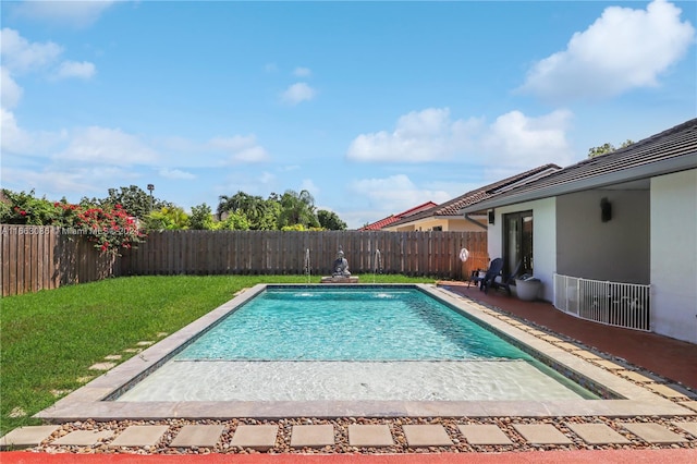 view of swimming pool with a patio and a yard