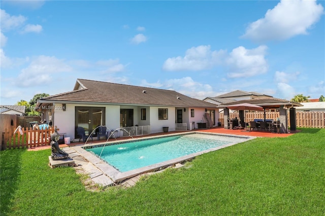 view of swimming pool featuring a lawn, a patio, and pool water feature