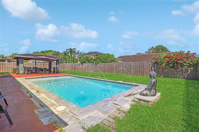 view of swimming pool with a gazebo, a lawn, a patio, and pool water feature