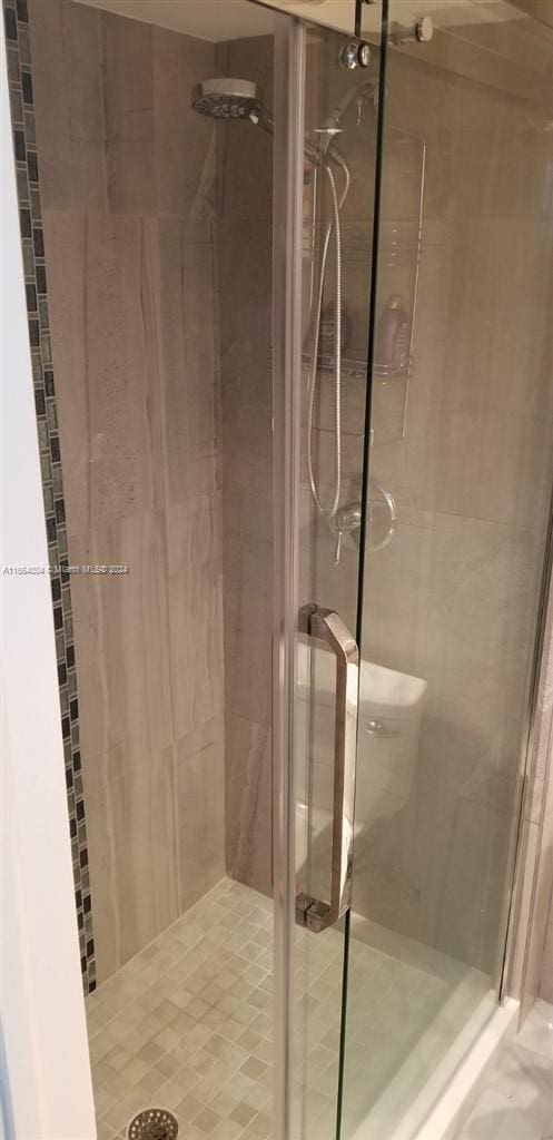 bathroom featuring a shower with shower door