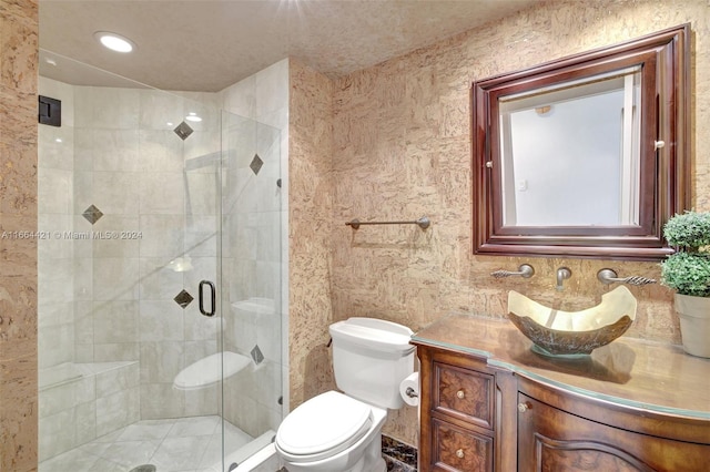 bathroom featuring vanity, toilet, walk in shower, and tile walls