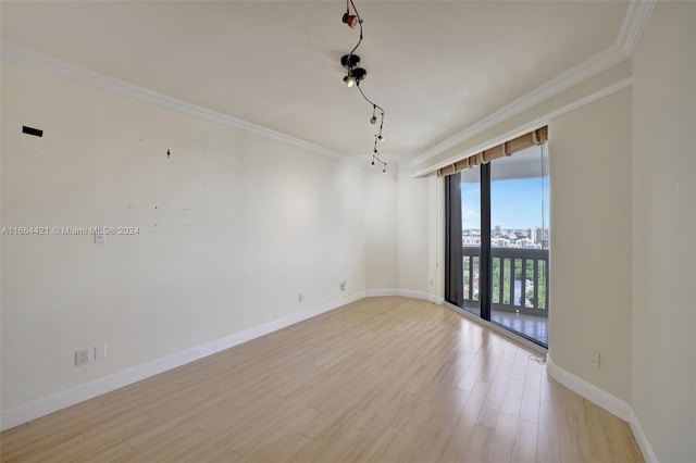 unfurnished room featuring light hardwood / wood-style flooring and crown molding