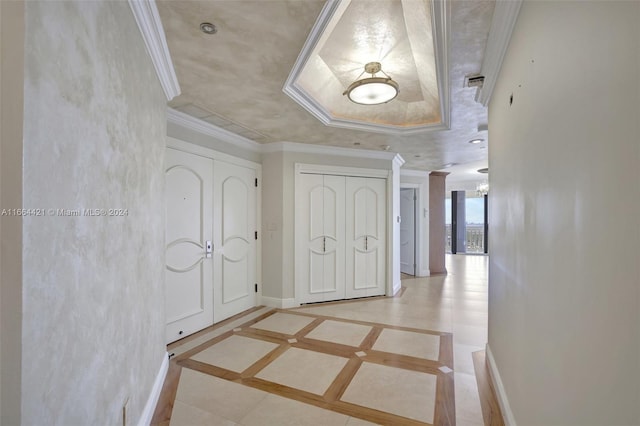 hallway with light tile patterned floors and crown molding